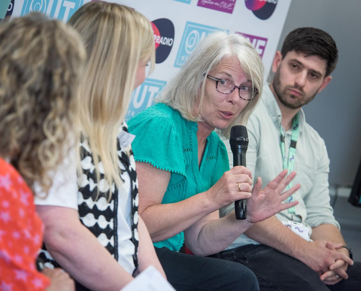 Panel members speaking with microphone