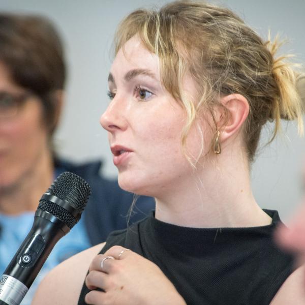 Woman speaking on microphone from audience